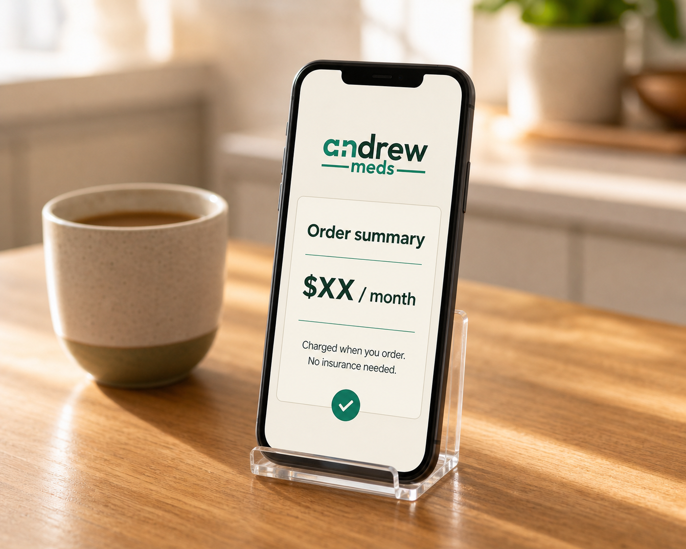 Phone on a warm kitchen counter showing an Andrew Meds order summary card.